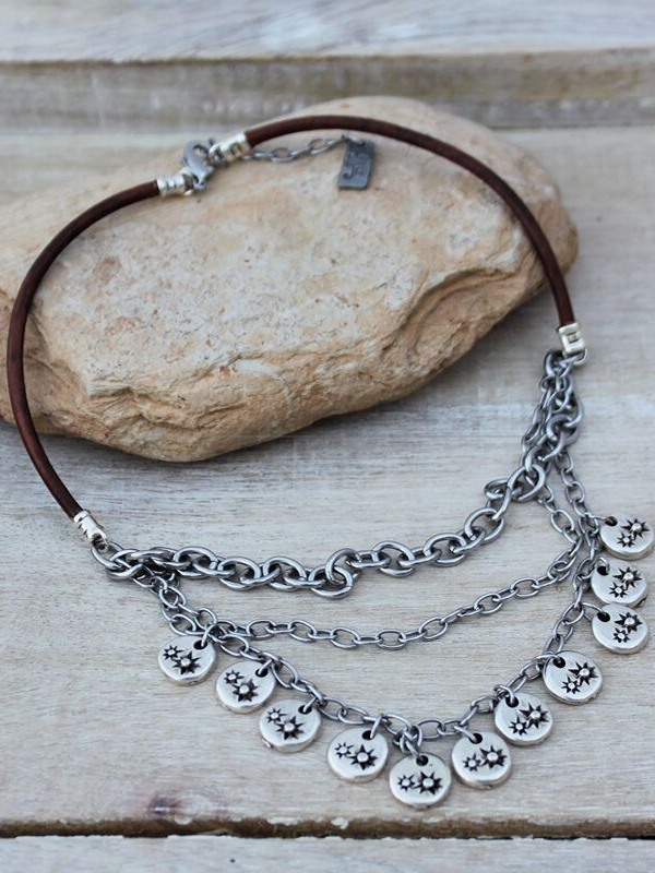a leather and chain layered necklace on rock